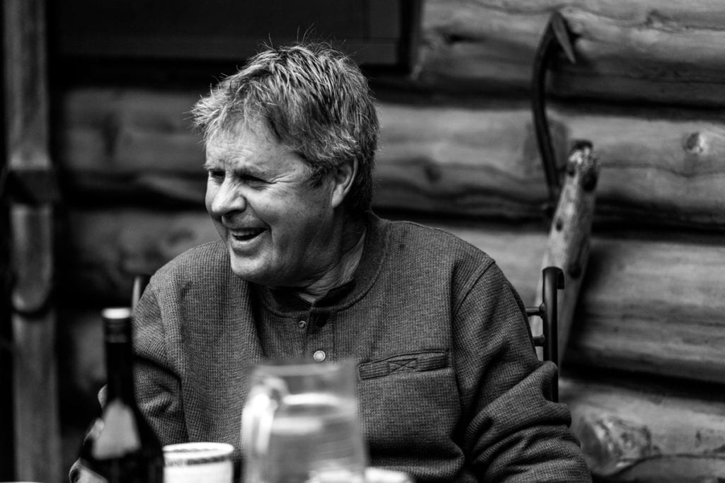 black and white shot of dad in waffle night shirt laughing and enjoying family
