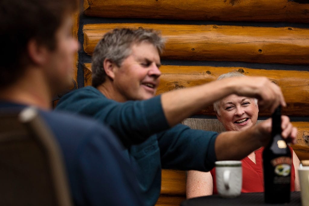 mom watching dad pour drinks in casual ontario family session