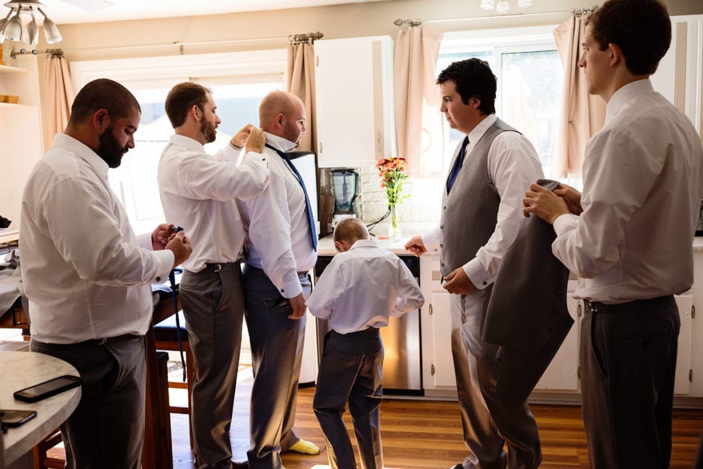 Cornwall groomsmen get ready in kitchen
