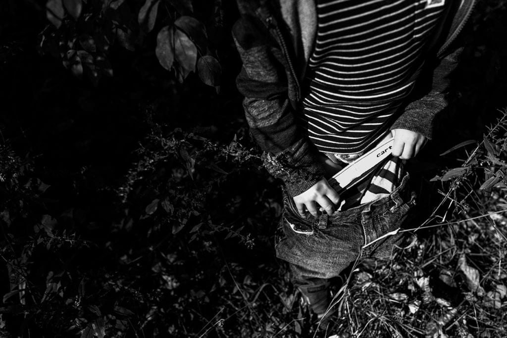 boy pulling up underwear on top of underwear