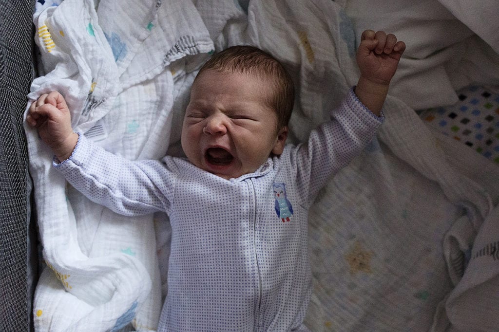 newborn stretching and yawning
