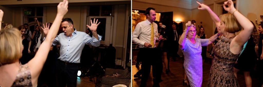 wedding guests dance with big arm gestures during wedding reception at Rhinefield House