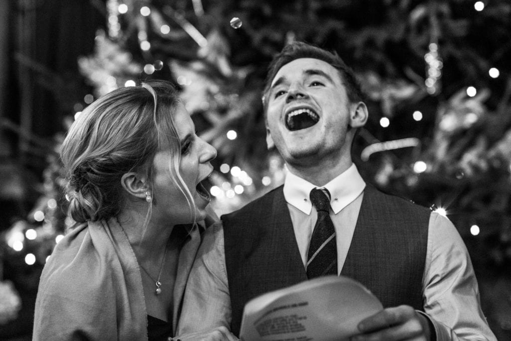 man and woman sing enthusiastically during wedding reception at Rhinefield House