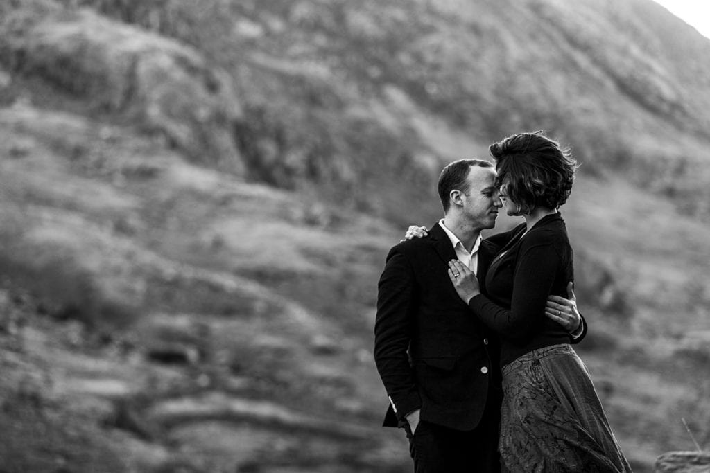 woman snuggles in to husband with mountains in the background during Snowdonia portrait session
