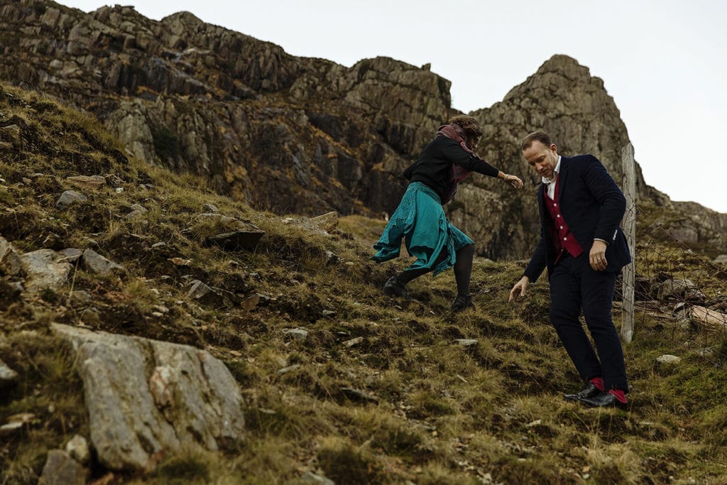 couple scramble down mountain in Snowdonia