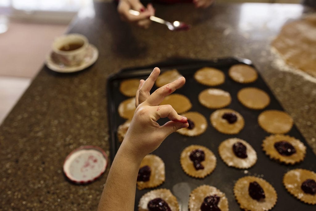 sticky jam fingers make okay sign while baking cookies