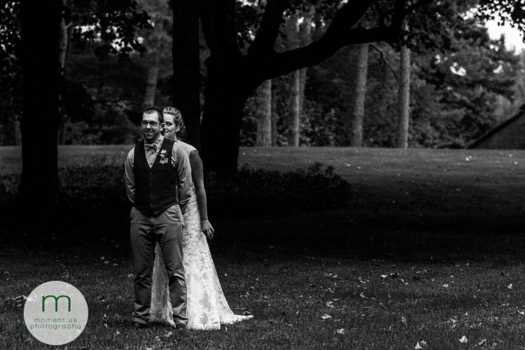 bride walks up behind groom for rural Ontario backyard wedding first look