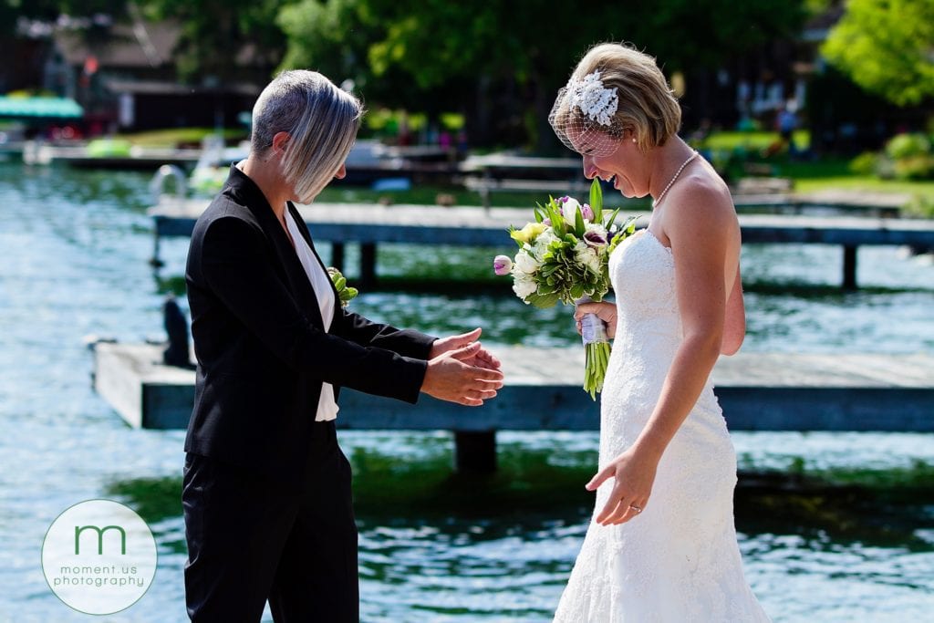 brides see each other for first time during waterfront Cornwall gay wedding first look