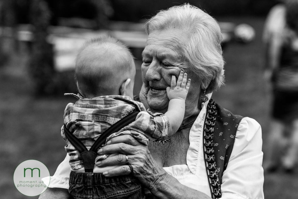 baby squishes grandmother's face