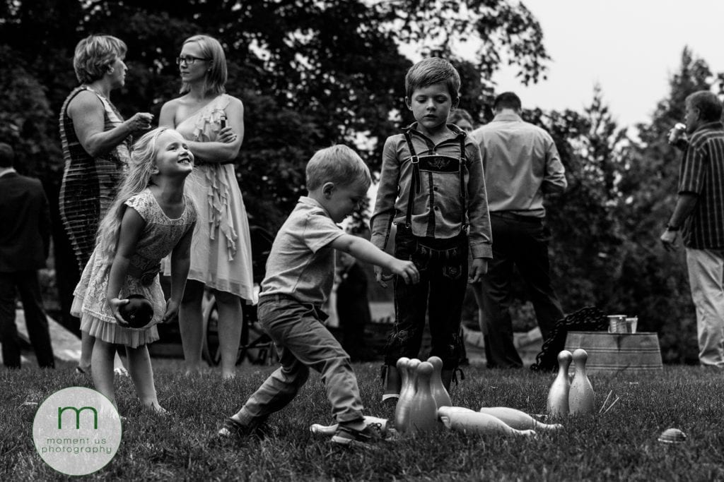 children play lawn bowling and pins fall down