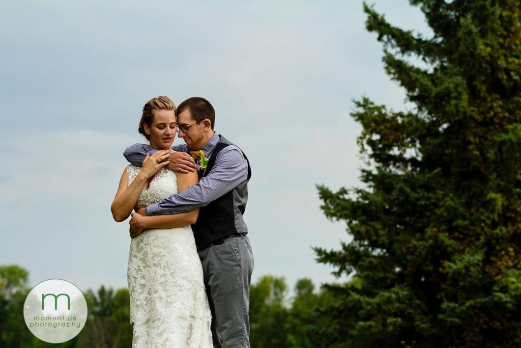 groom holds bride close during Ontario & Quebec Wedding Photography portraits