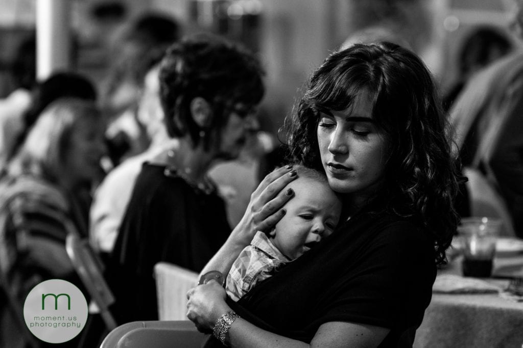 mother holds sleeping baby close to her while she closes her eyes