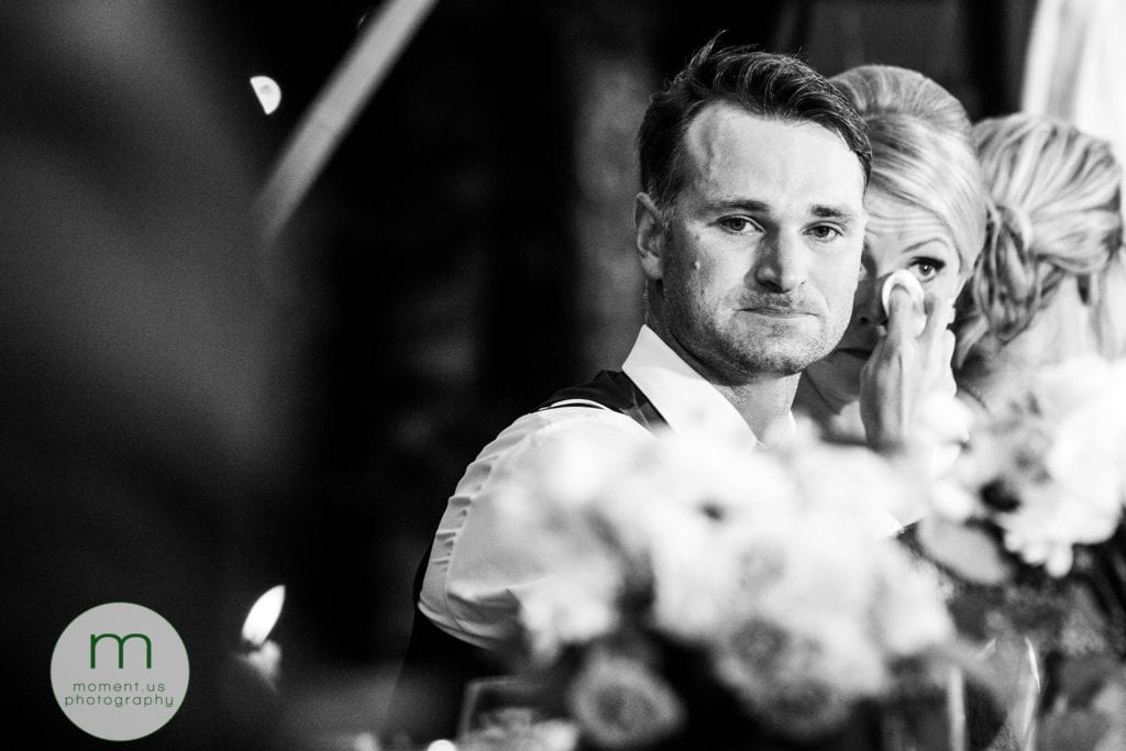groom tries not to cry while bride wipes her eyes