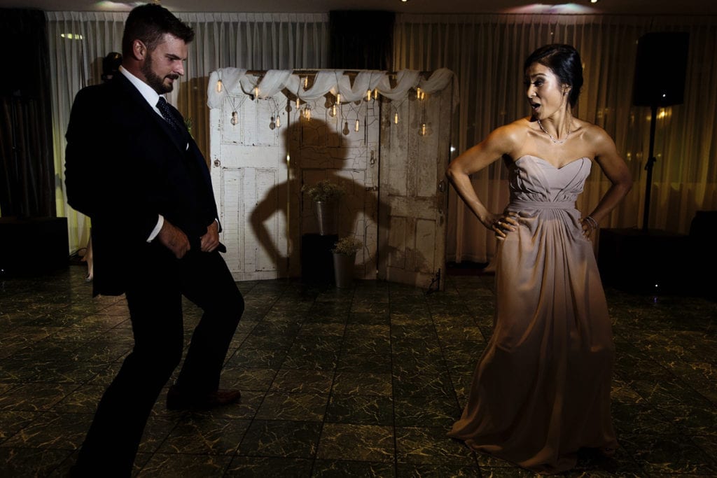 bridesmaid and groomsman dancing during entry into reception for Autumnal NAV Centre Cornwall Wedding