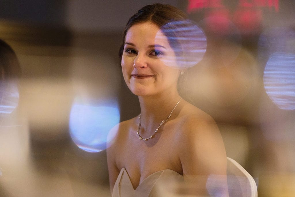 bridesmaid looking on during speeches with large bokeh spots