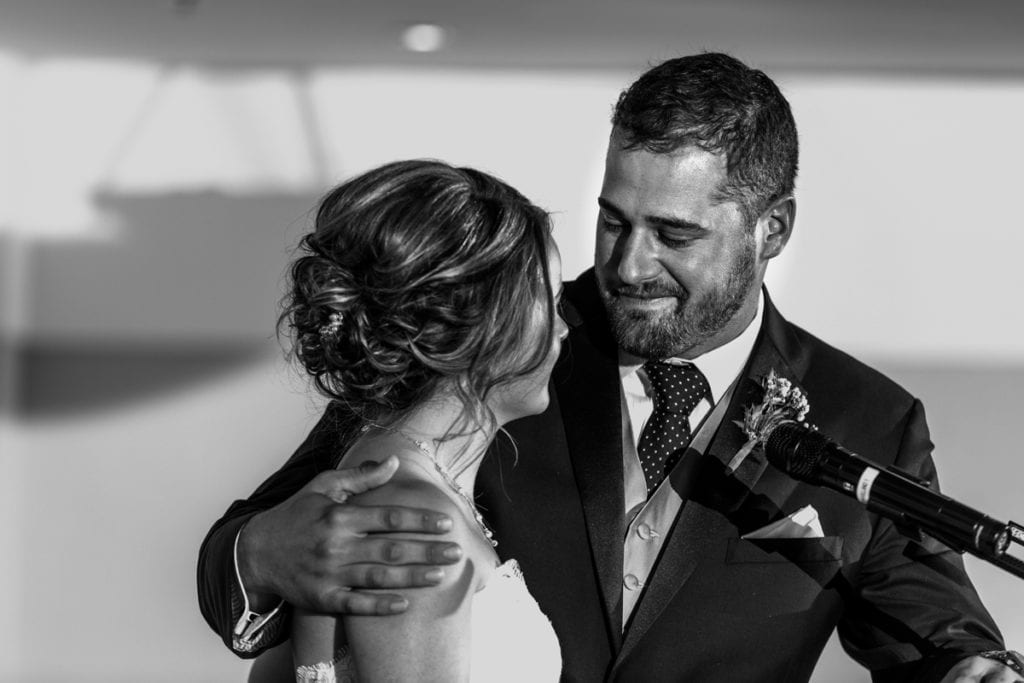 groom holding bride and looking at her during speeches for Autumnal NAV Centre Cornwall Wedding
