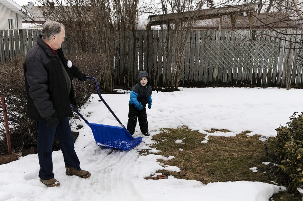 boy throws snowball at grandpa during last days of winter