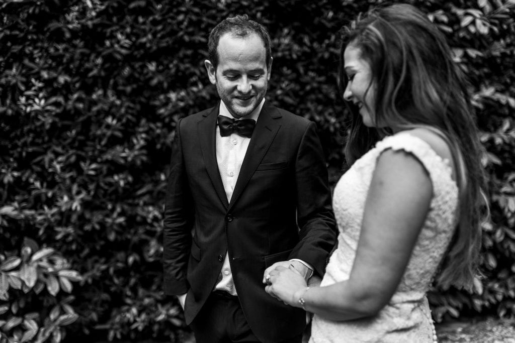 bride and groom touch hands during session with Ontario & Destination Wedding Photographer