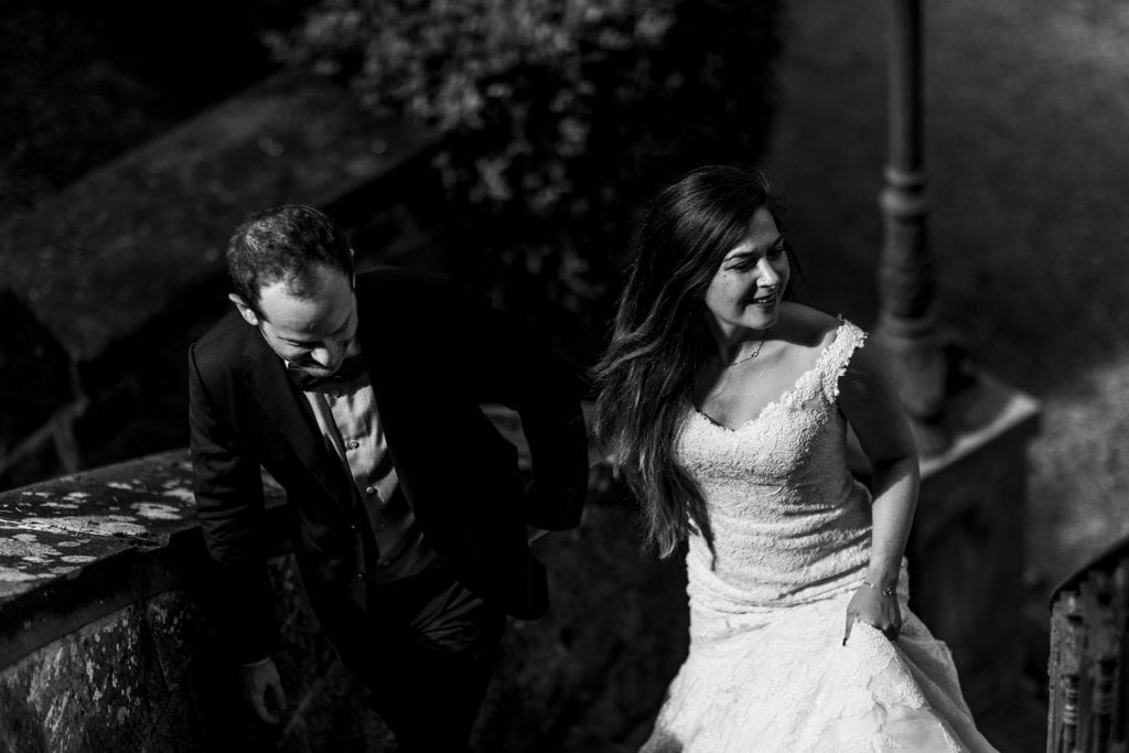 Bride and groom walk up Italian villa stairs during session with Ontario & Destination Wedding Photographer