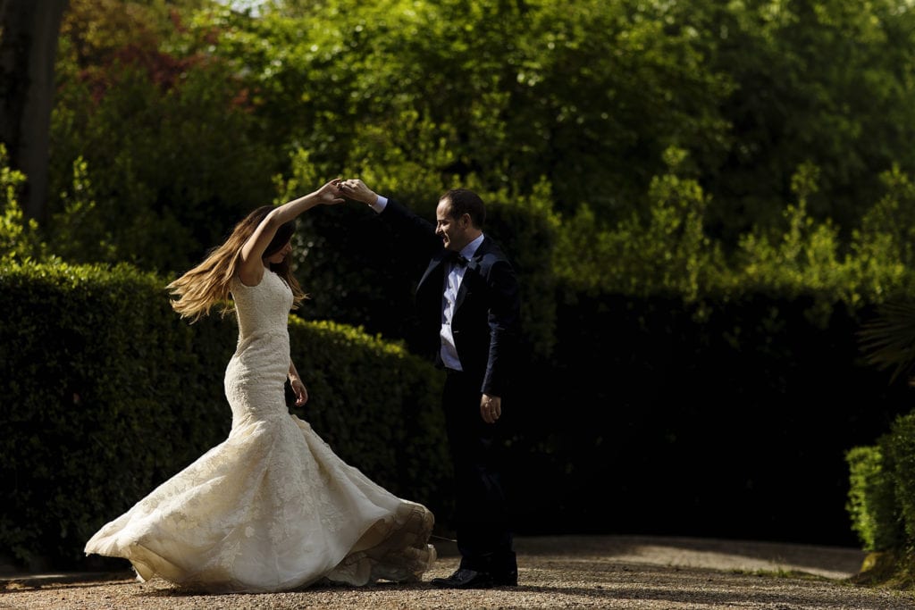 groom twirls bride wearing fit and flare gown during session with Ontario & Destination Wedding Photographer