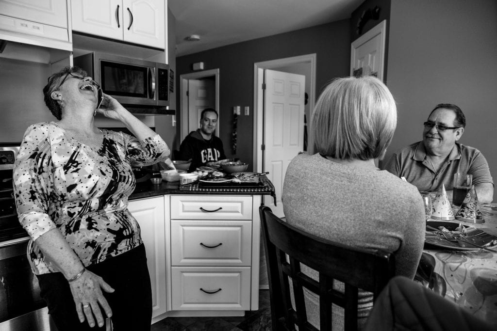 grandma laughs enthusiastically while on phone with grandson who is in other room