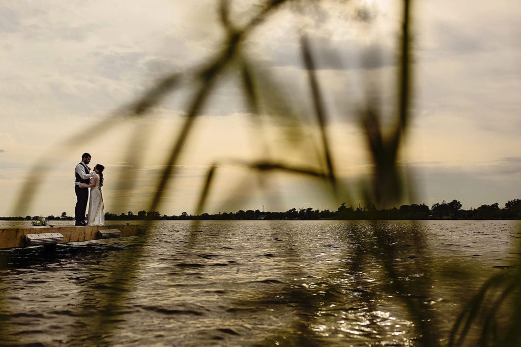 Bride and groom on dock along St Lawrence river