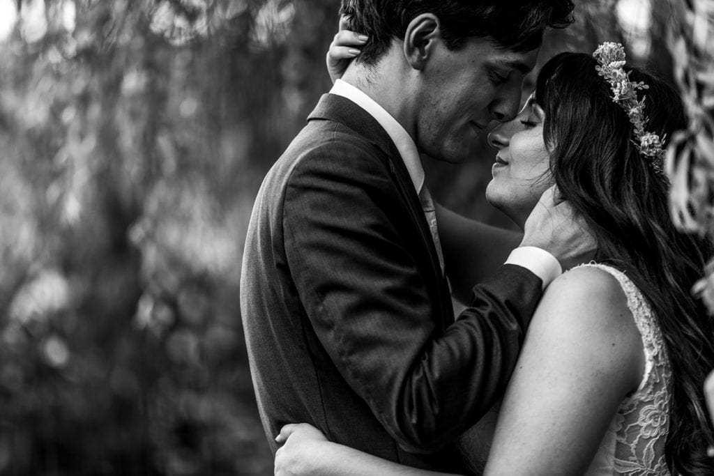 bride and groom snuggle under willow at Strathmere