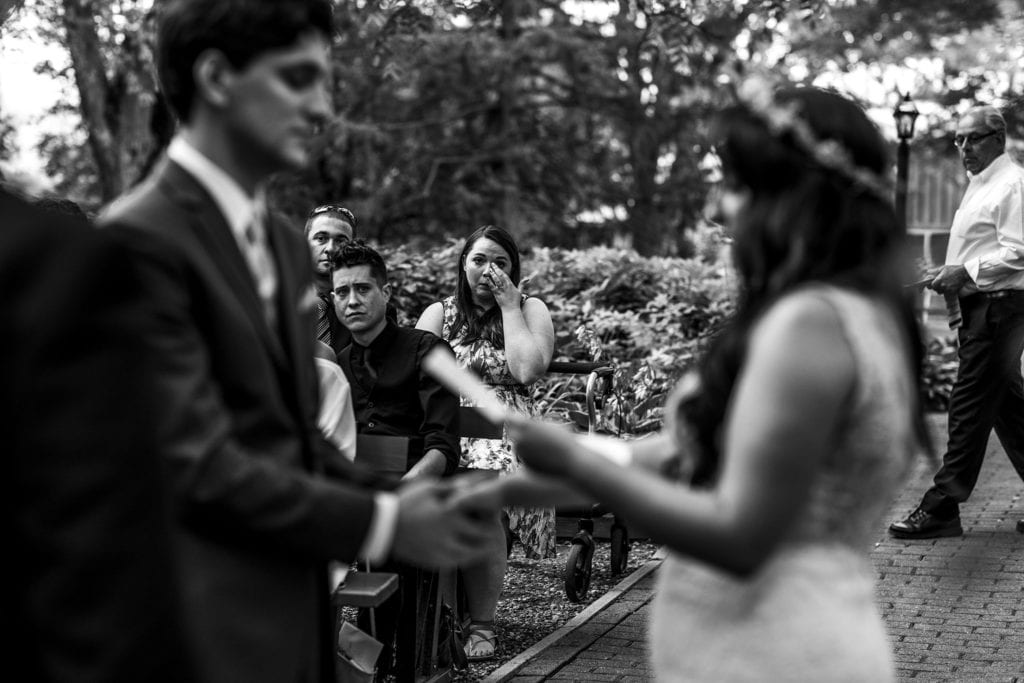 guest wipes eyes during Strathmere wedding vows