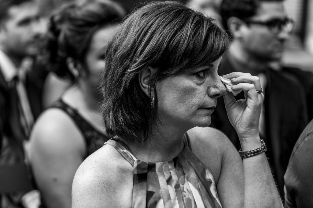 Stepmother of the groom wipes eyes during Strathmere wedding