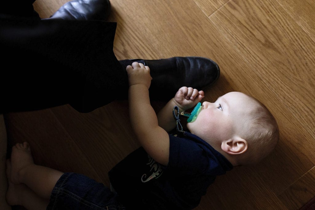 grandson plays with grandpa's shoe