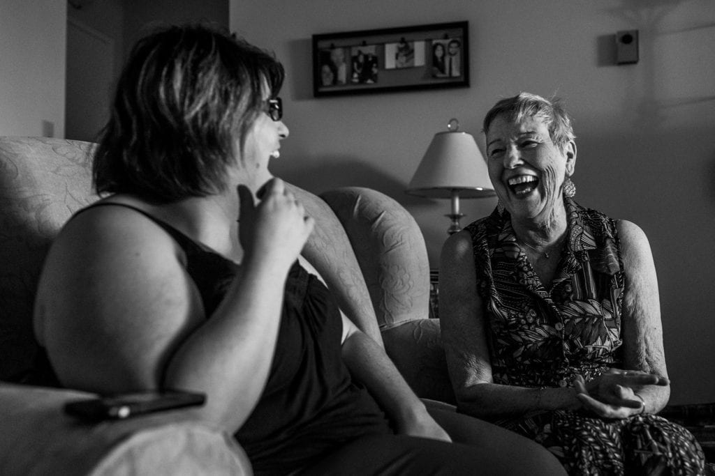 grandmother and granddaughter laugh together