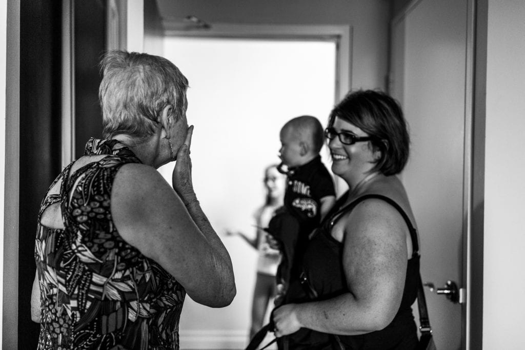 grandmother blows kisses to granddaughter and great grandson