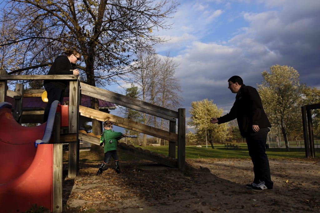 family plays ball at playground for Cornwall fall family photos