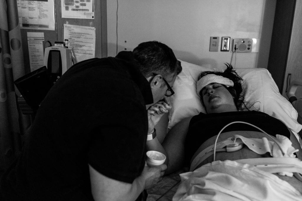 Woman kisses wife's hand during contractions