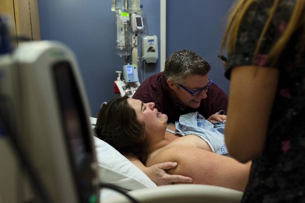 Woman hugs wife while son is born