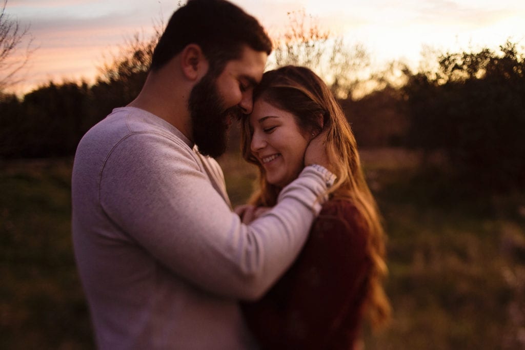 man with hands in woman's hair at romantic Cornwall Autumn Engagement Session