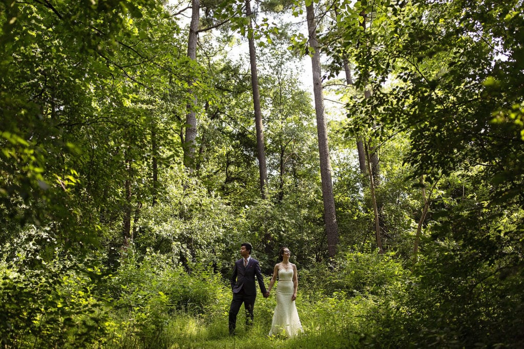 bride and groom in stunning green natural forest at intimate vincent massey park wedding