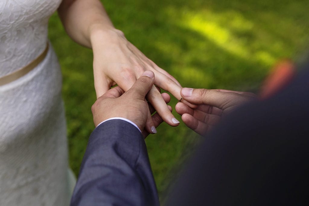 couple exchange wedding rings during intimate ottawa park wedding