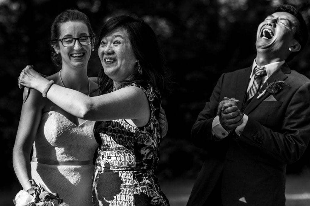 bride and groom share a laugh with wedding guest at intimate ottawa park wedding