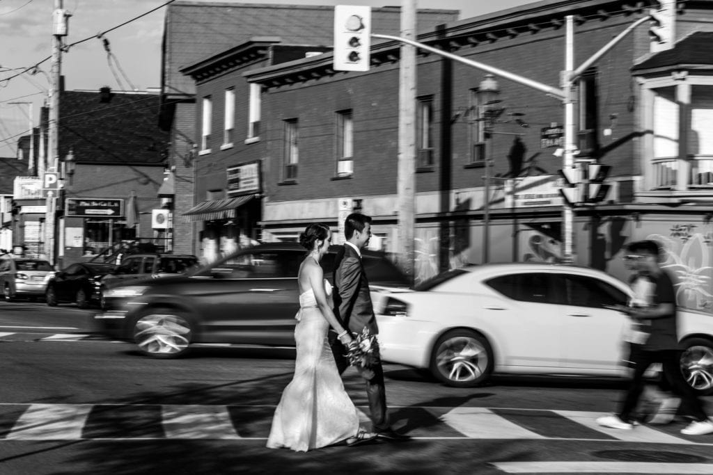 bride and groom cross busy city street