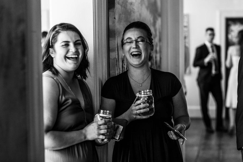 two women laugh together
