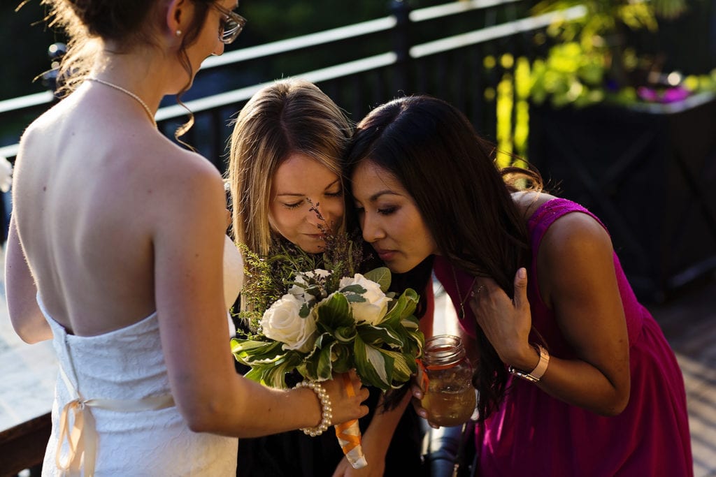 girls bend and smell bride's bouquet