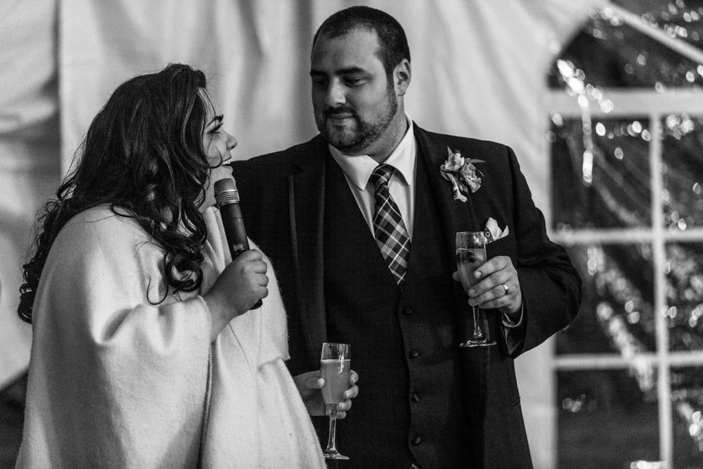 bride and groom look at one another during speech