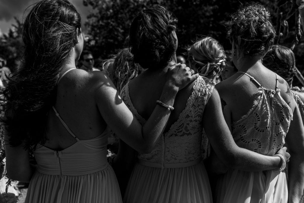 bridesmaids each wrap arms around the next