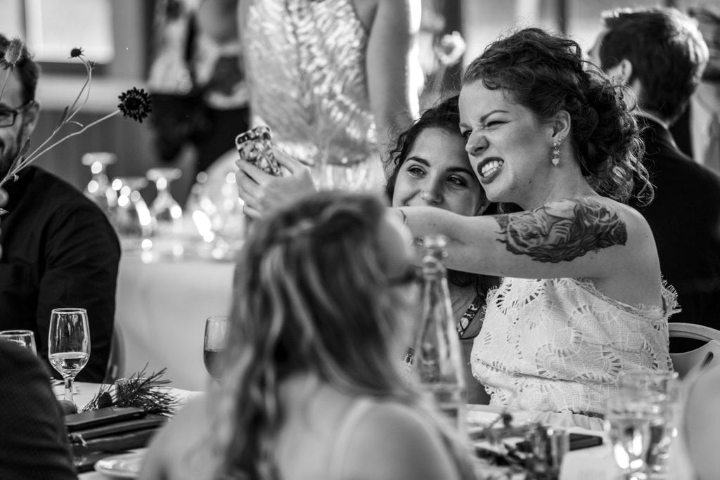 two women take selfie while one makes silly face
