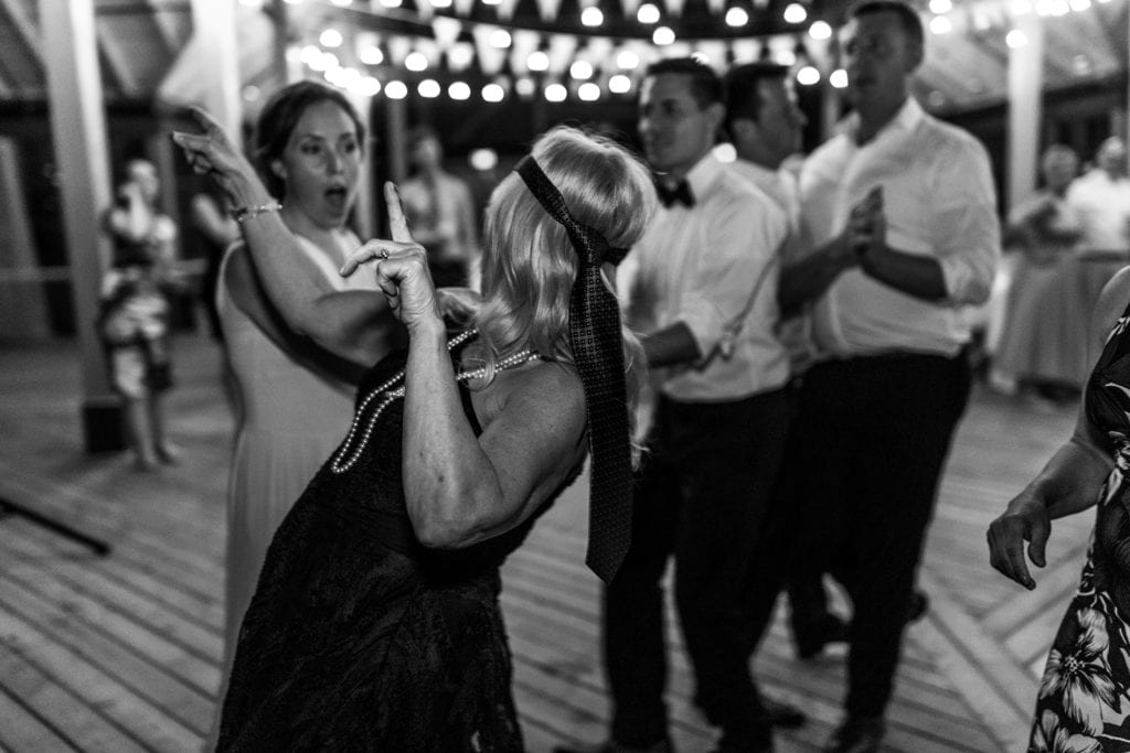 woman with tie on her hand dances with pointed fingers
