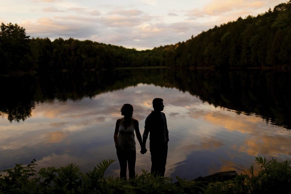 couple holding hands at sunset in Gatineau Park engagement session