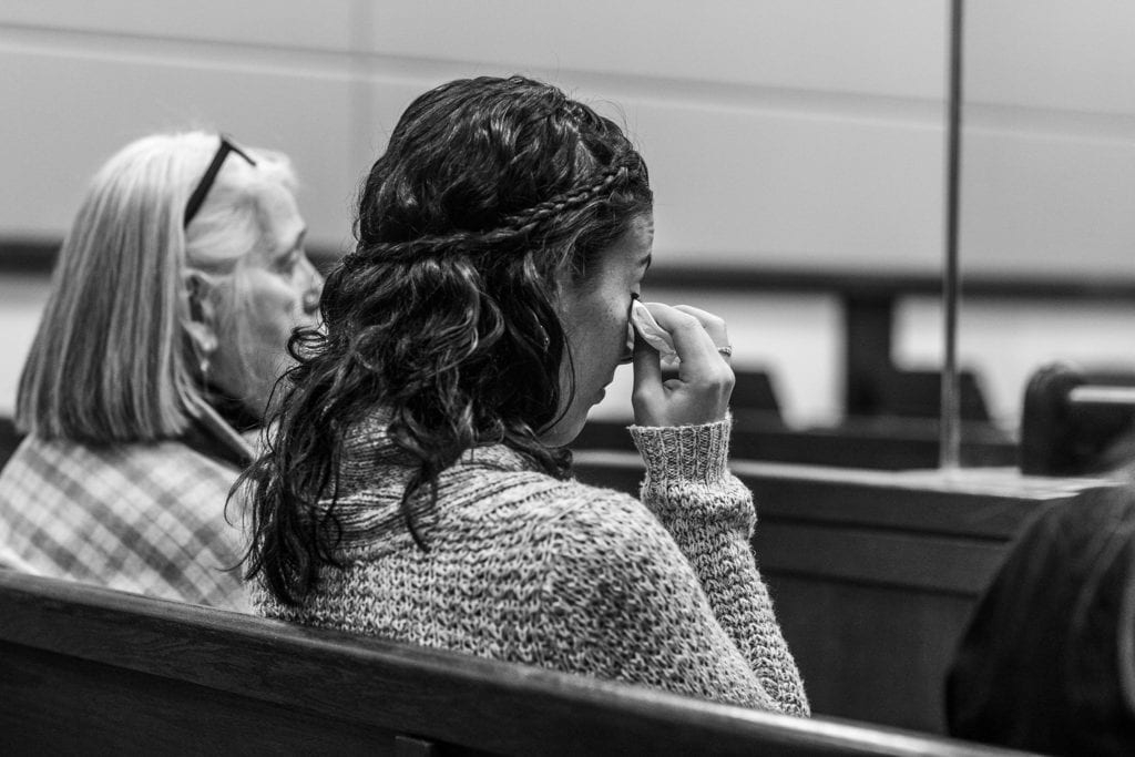 family member dabs away happy tears at adoption ceremony in cornwall ontario courthouse