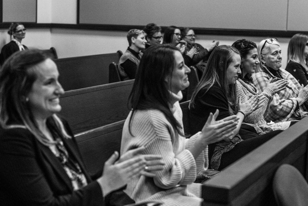 family look on and applaud adoption ceremony at courthouse in Cornwall
