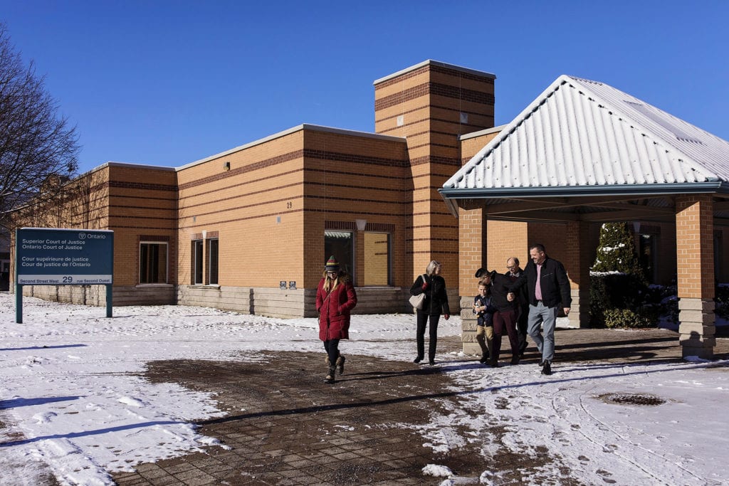 family leaving courthouse celebrates adoption on winter day in Cornwall